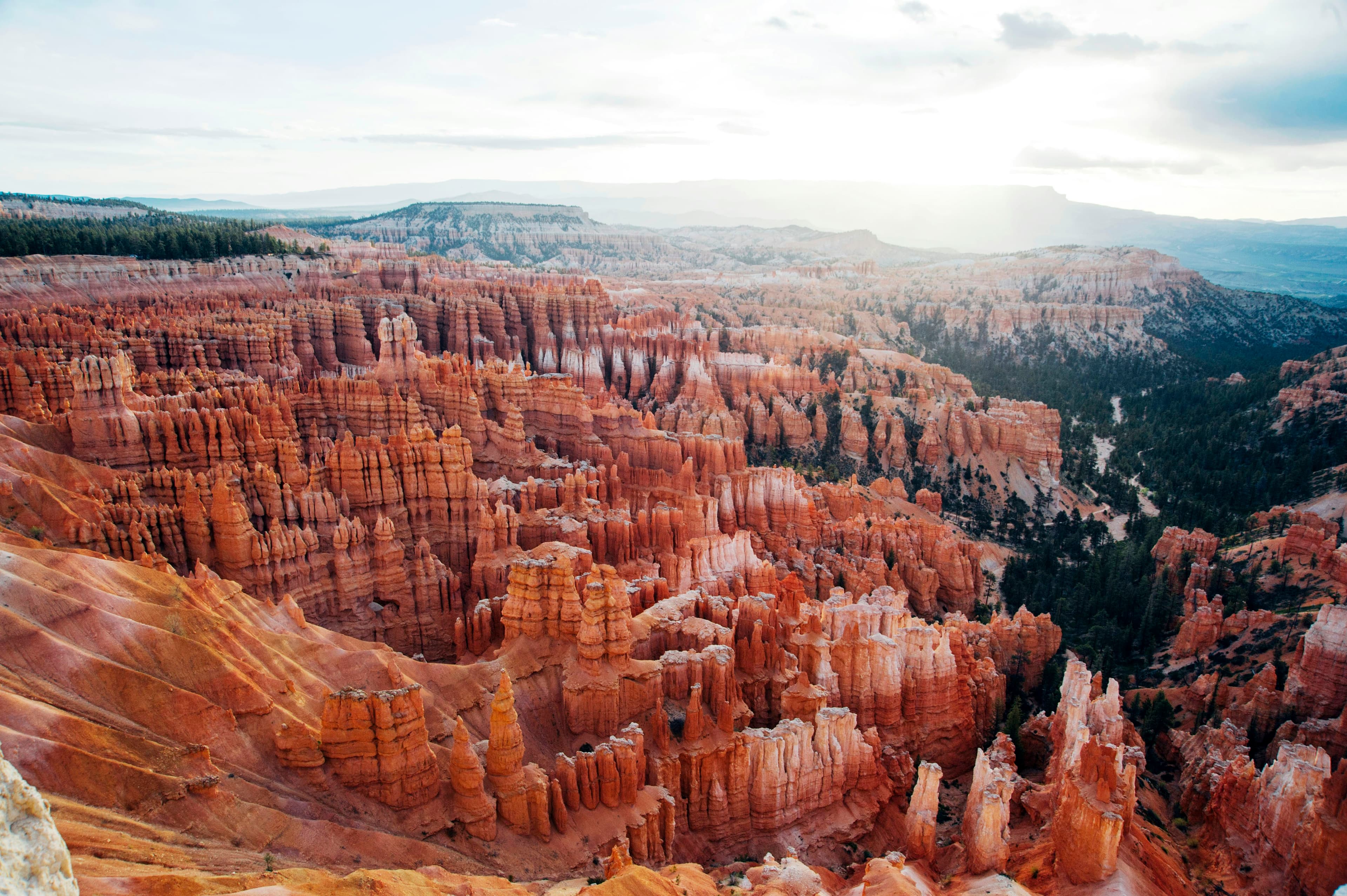 Aerial view of layered orange and red canyon rock formations at Bryce Canyon National Park in daylight